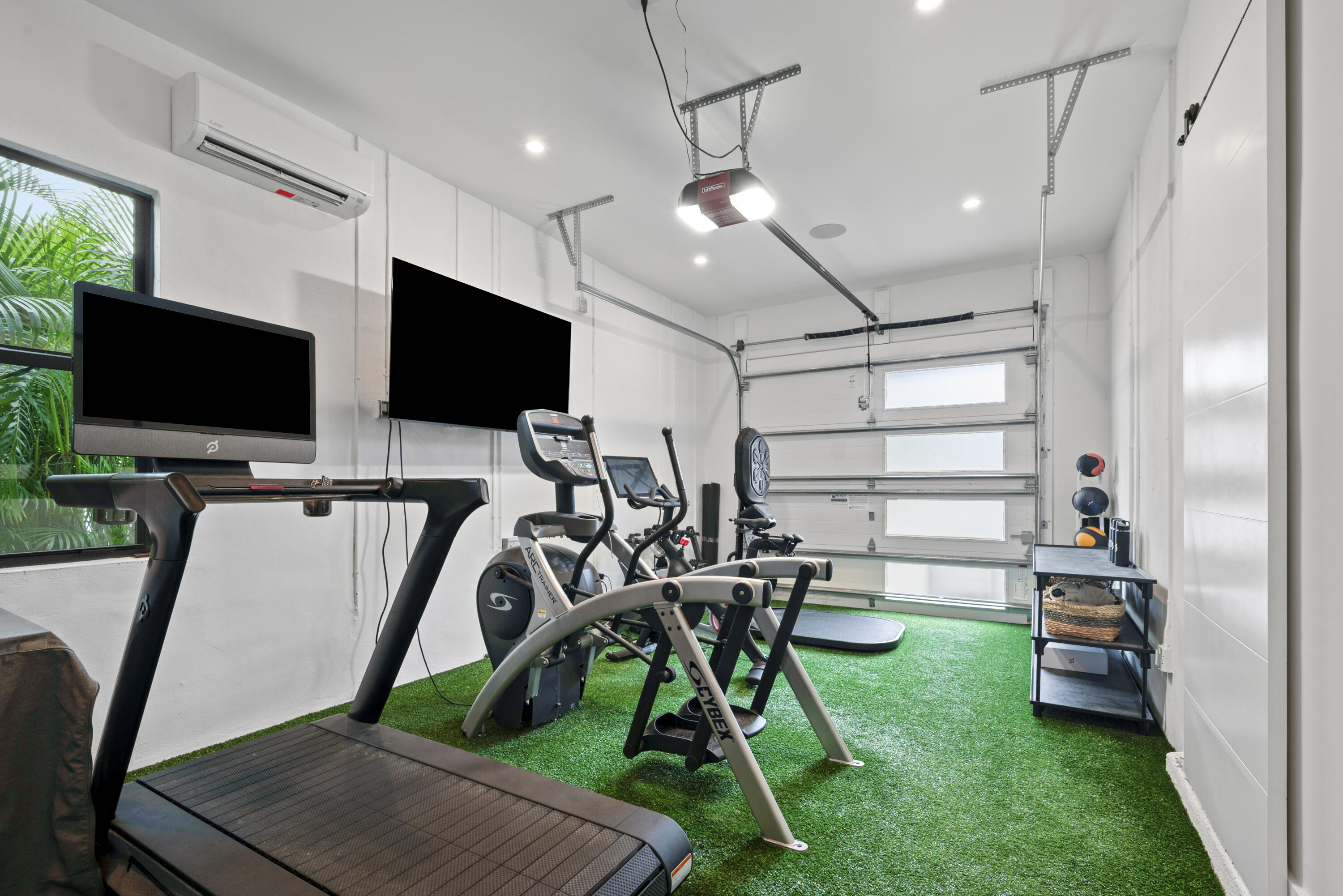 9771 Chianti Classico Terrace Boca Raton, FL 33496 - Photo 43 of 114 a view of a room with gym equipment and a flat screen tv