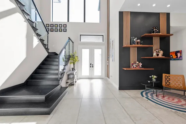 a living room with furniture a floor to ceiling window and a flat screen tv