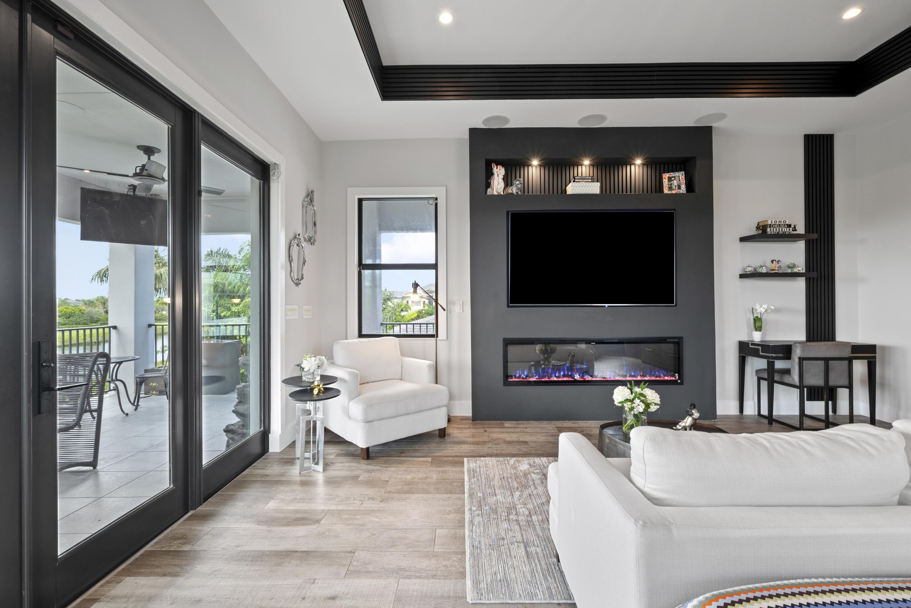 9771 Chianti Classico Terrace Boca Raton, FL 33496 - Photo 56 of 114 a living room with furniture a flat screen tv and a fireplace