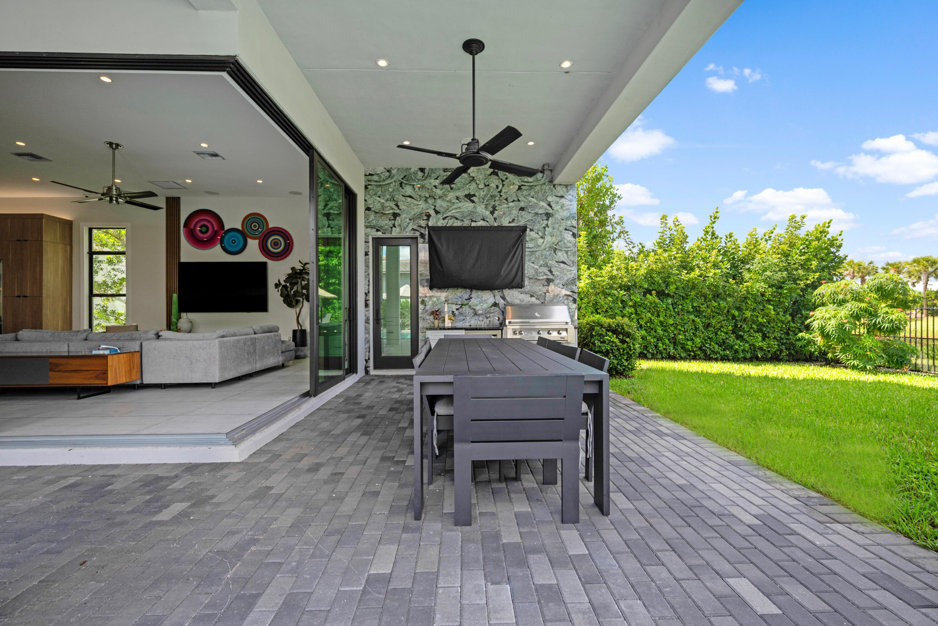 9771 Chianti Classico Terrace Boca Raton, FL 33496 - Photo 84 of 114 a view of a porch with chairs and a yard