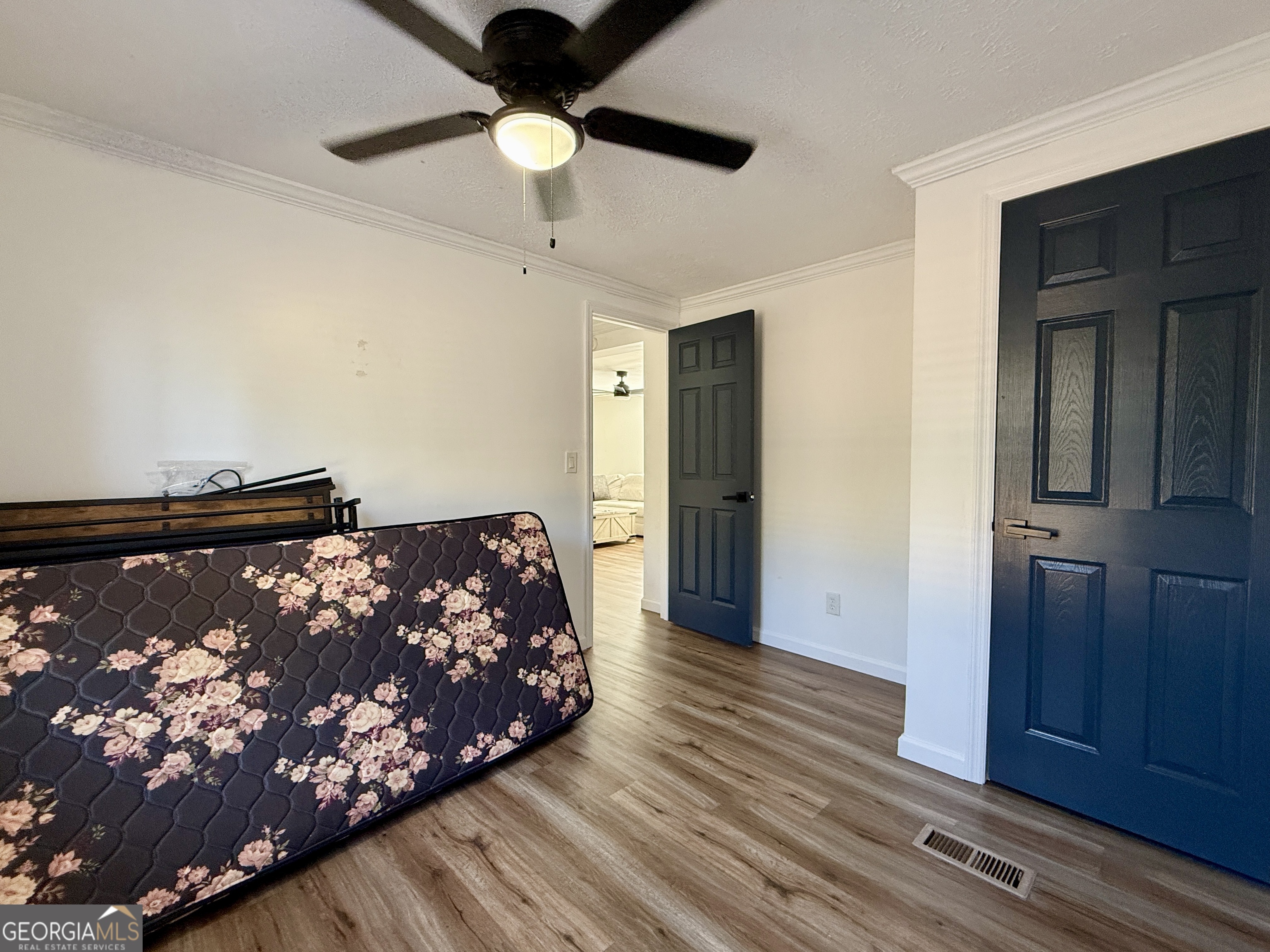 10199 Ga Highway Stapleton, GA 30823 - Photo 17 of 30 a bedroom with a bed and wooden floor