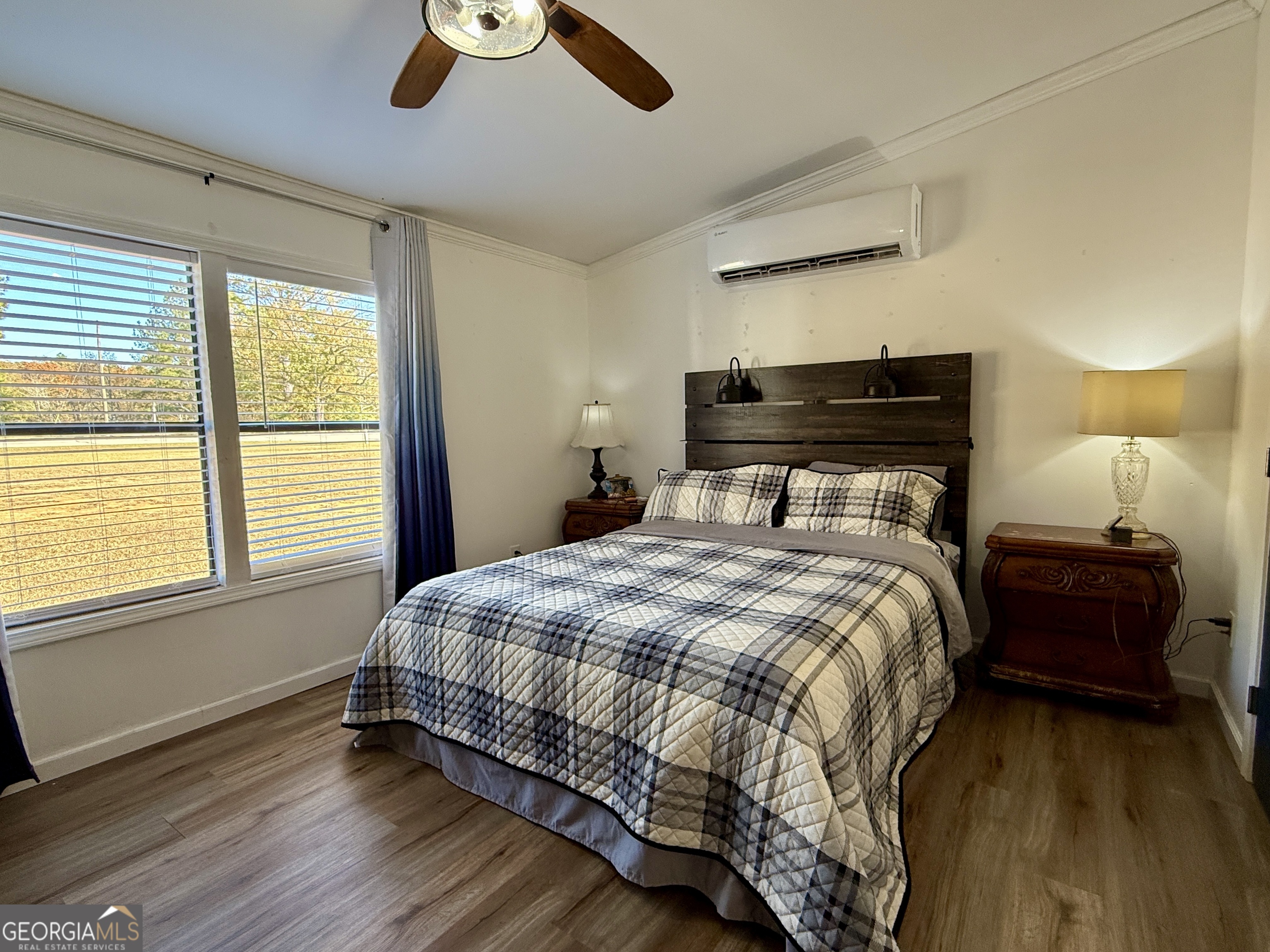 10199 Ga Highway Stapleton, GA 30823 - Photo 24 of 30 a bedroom with a bed and wooden floor