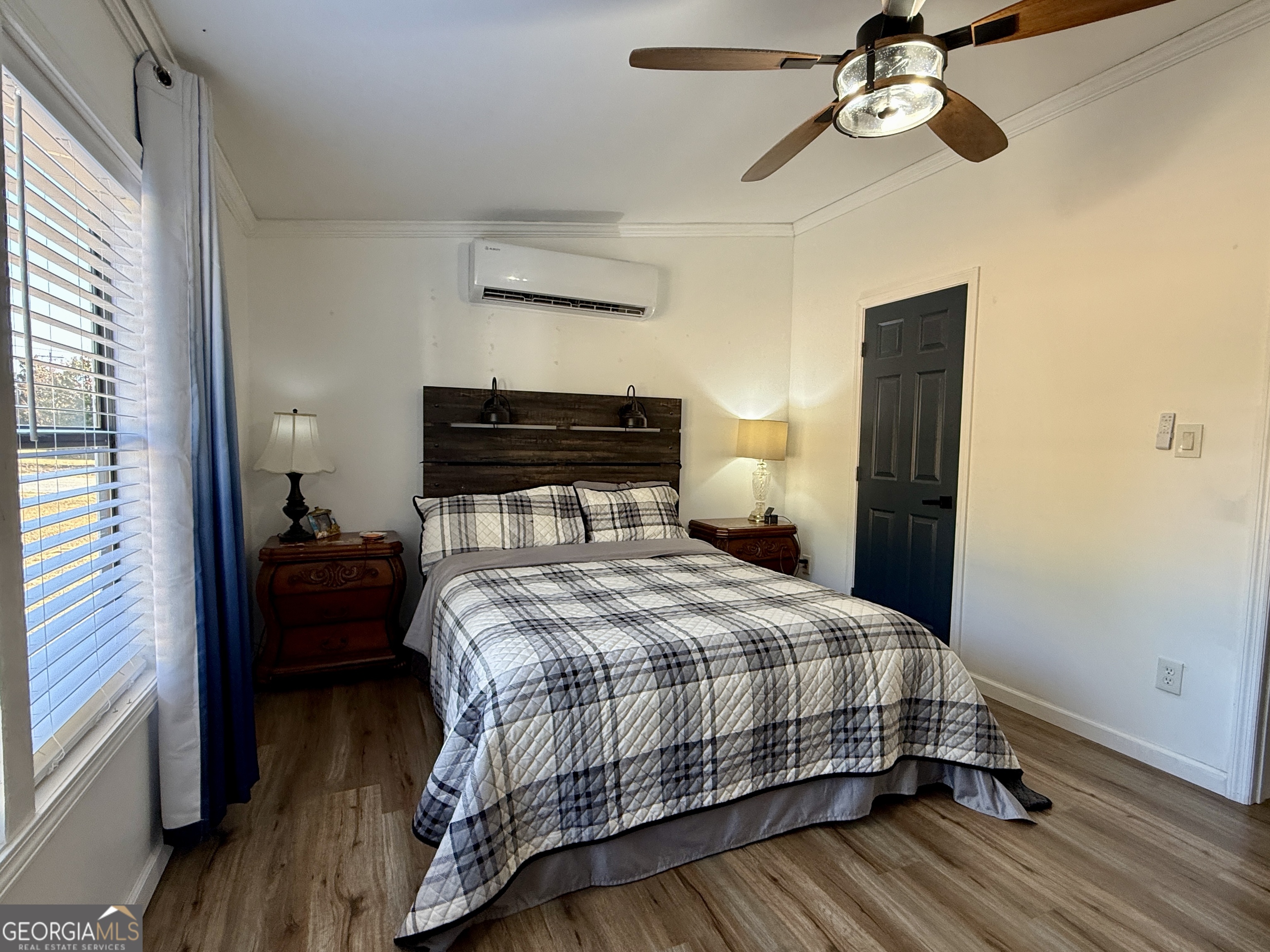 10199 Ga Highway Stapleton, GA 30823 - Photo 25 of 30 a bedroom with a bed and wooden floor
