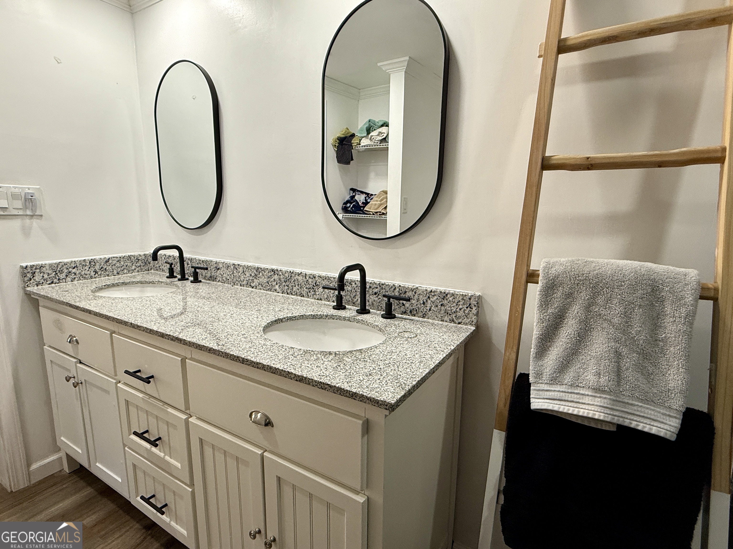 10199 Ga Highway Stapleton, GA 30823 - Photo 26 of 30 a bathroom with a granite countertop sink a mirror and a