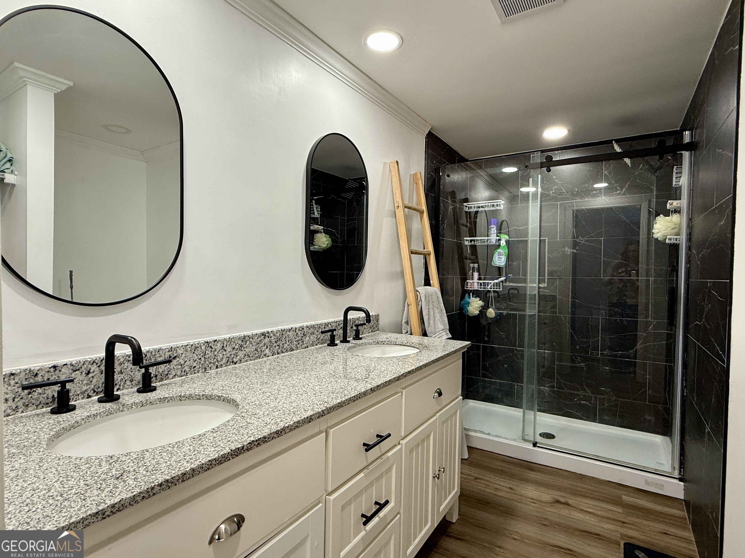 10199 Ga Highway Stapleton, GA 30823 - Photo 27 of 30 a bathroom with a double vanity sink and a mirror