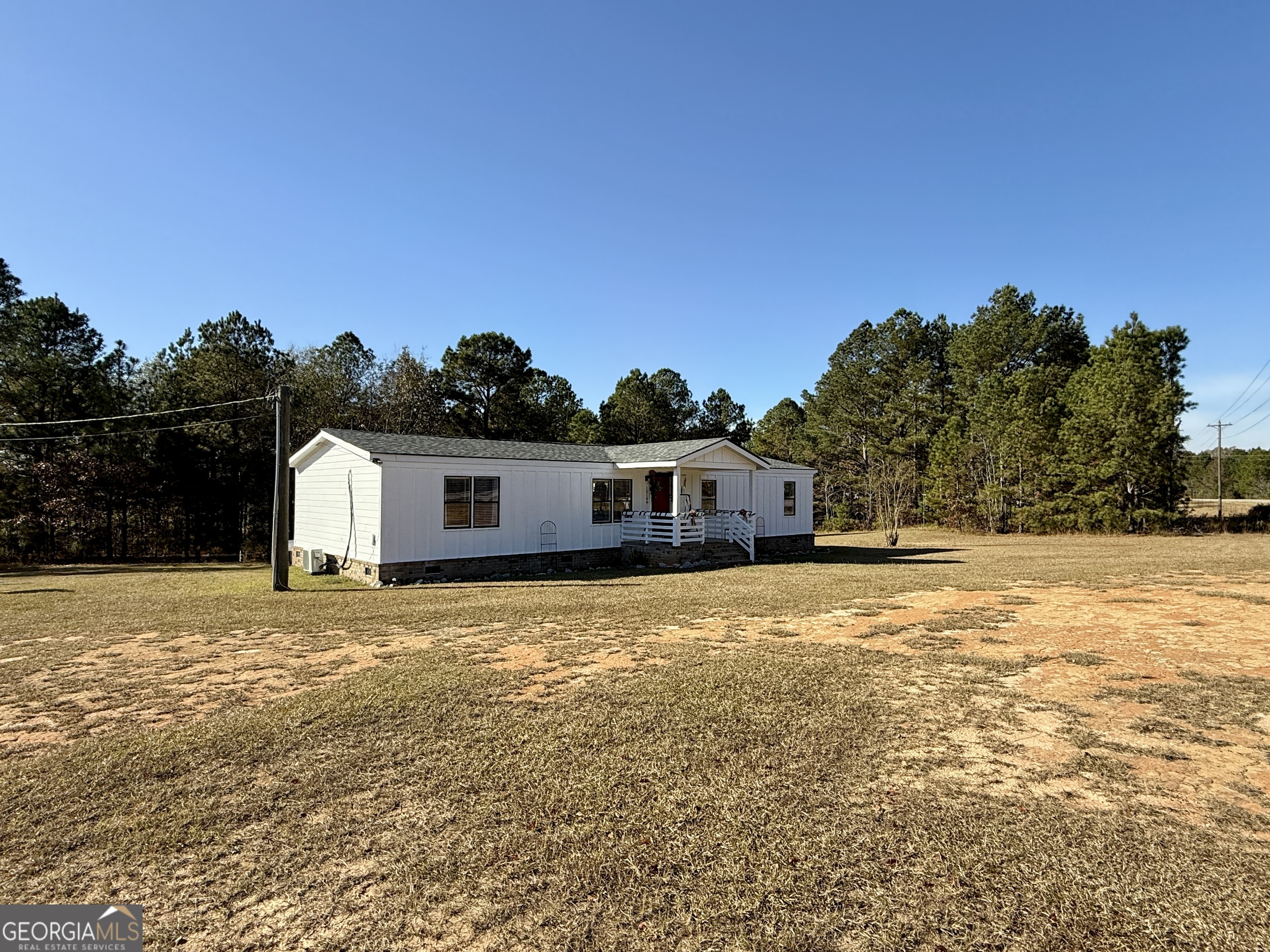 10199 Ga Highway Stapleton, GA 30823 - Photo 7 of 30 a front view of a house with a yard
