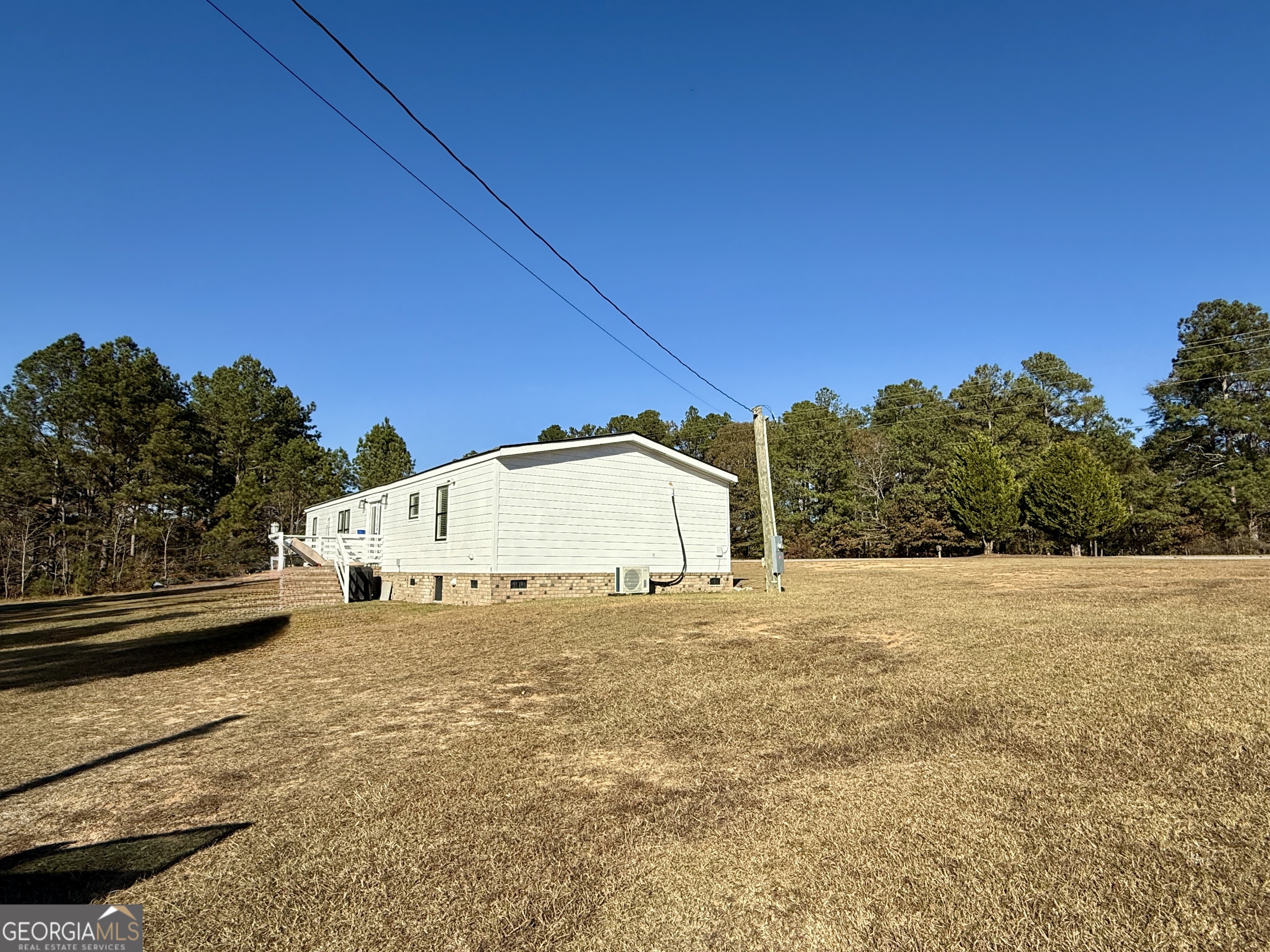 10199 Ga Highway Stapleton, GA 30823 - Photo 8 of 30 a view of a house with a yard and garage