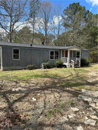 a backyard of a house with yard and outdoor seating