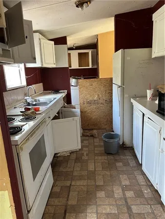 a kitchen with a stove and a refrigerator