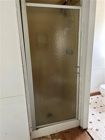 a bathroom with a glass shower door