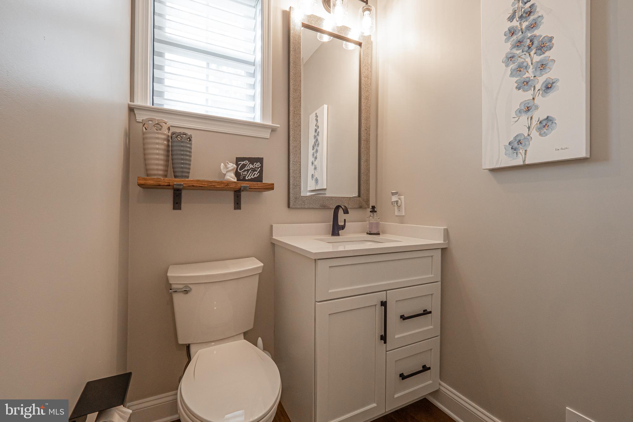 8 Timber Mill Lane, Unit TAGLIO Landenberg, PA 19350 - Photo 32 of 42 a bathroom with a toilet sink and mirror