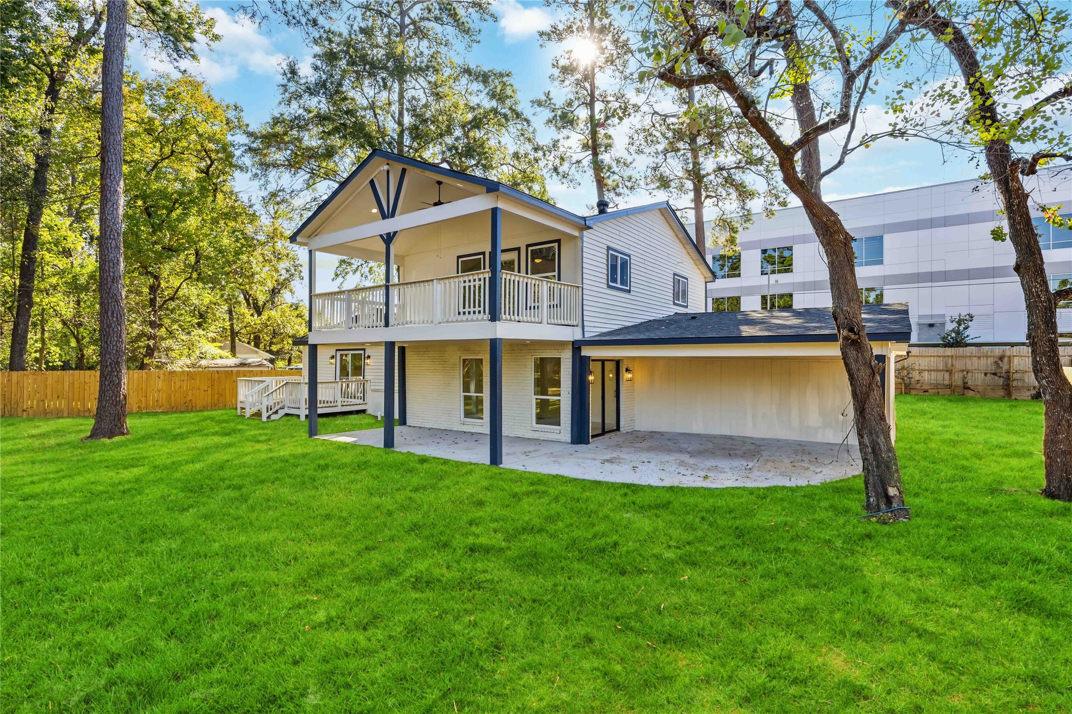 18234 Atkinson Lane Conroe, TX 77384 - Photo 24 of 30 a view of a house with a yard patio and a tree