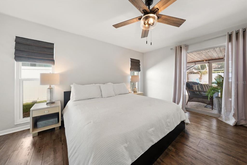 1049 McCarty Street Dunedin, FL 34698 - Photo 11 of 49 a bedroom with bed and a chandelier
