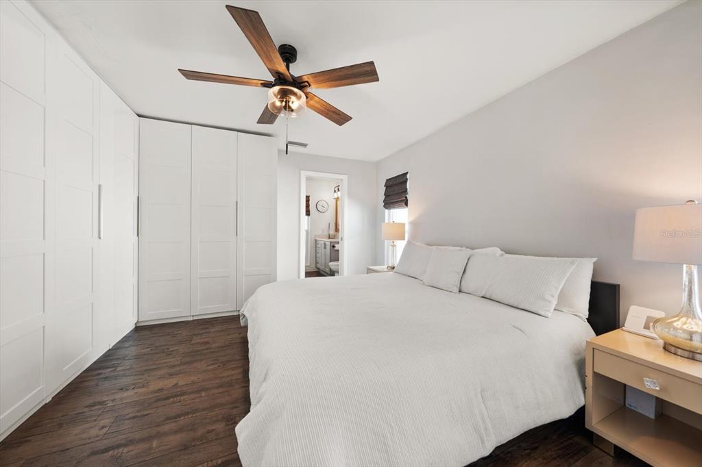 1049 McCarty Street Dunedin, FL 34698 - Photo 12 of 49 a bedroom with a bed and a chandelier