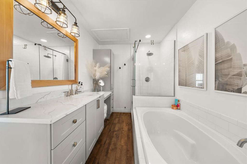 1049 McCarty Street Dunedin, FL 34698 - Photo 13 of 49 a spacious bathroom with a granite countertop tub sink shower and mirror
