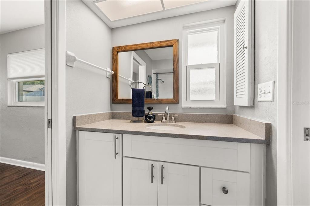 1049 McCarty Street Dunedin, FL 34698 - Photo 16 of 49 a bathroom with a sink and a mirror