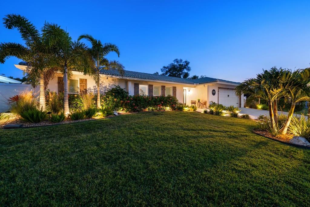 1049 McCarty Street Dunedin, FL 34698 - Photo 2 of 49 a view of a house with a big yard
