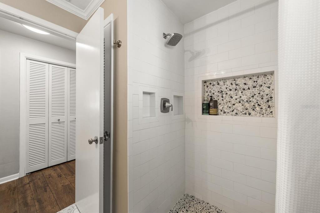 1049 McCarty Street Dunedin, FL 34698 - Photo 22 of 49 a bathroom with a shower and a sink