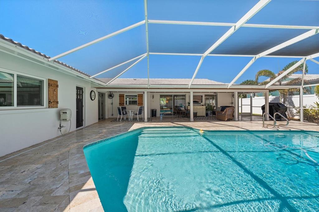 1049 McCarty Street Dunedin, FL 34698 - Photo 35 of 49 a view of a patio with table and chairs under an umbrella