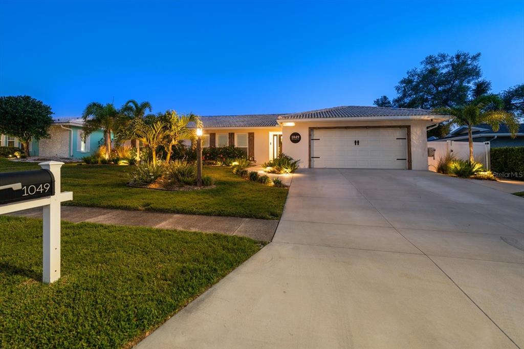 1049 McCarty Street Dunedin, FL 34698 - Photo 47 of 49 a view of a house with backyard and trees