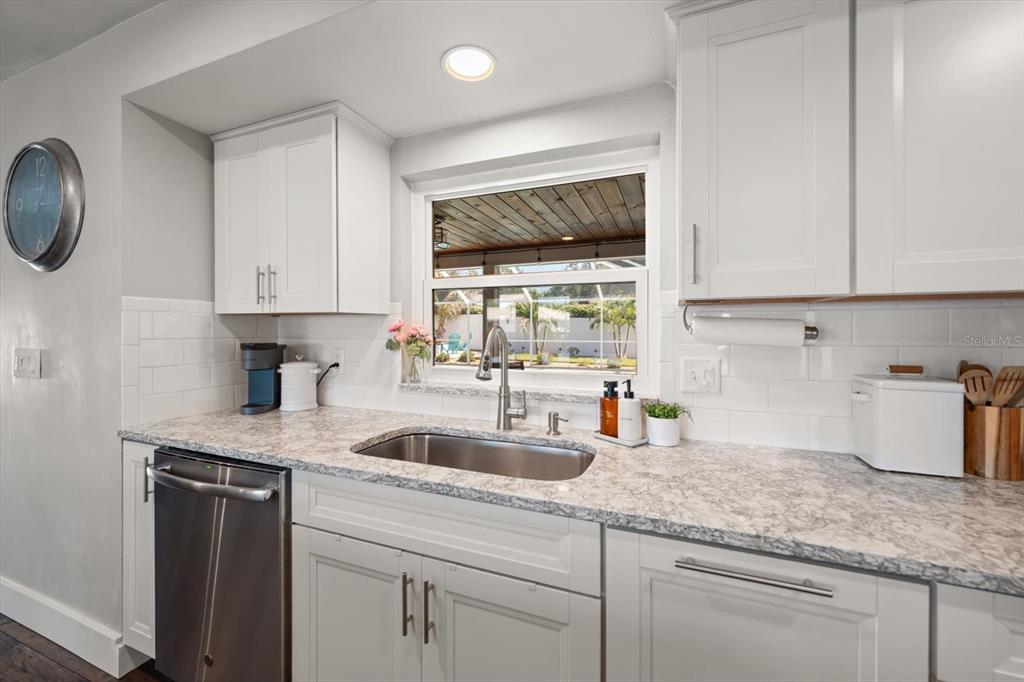 1049 McCarty Street Dunedin, FL 34698 - Photo 5 of 49 a kitchen with sink cabinets and window