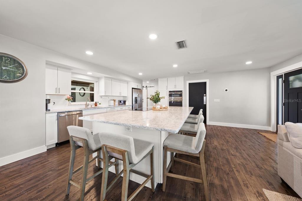 1049 McCarty Street Dunedin, FL 34698 - Photo 7 of 49 a view of a dining room with furniture and wooden floor