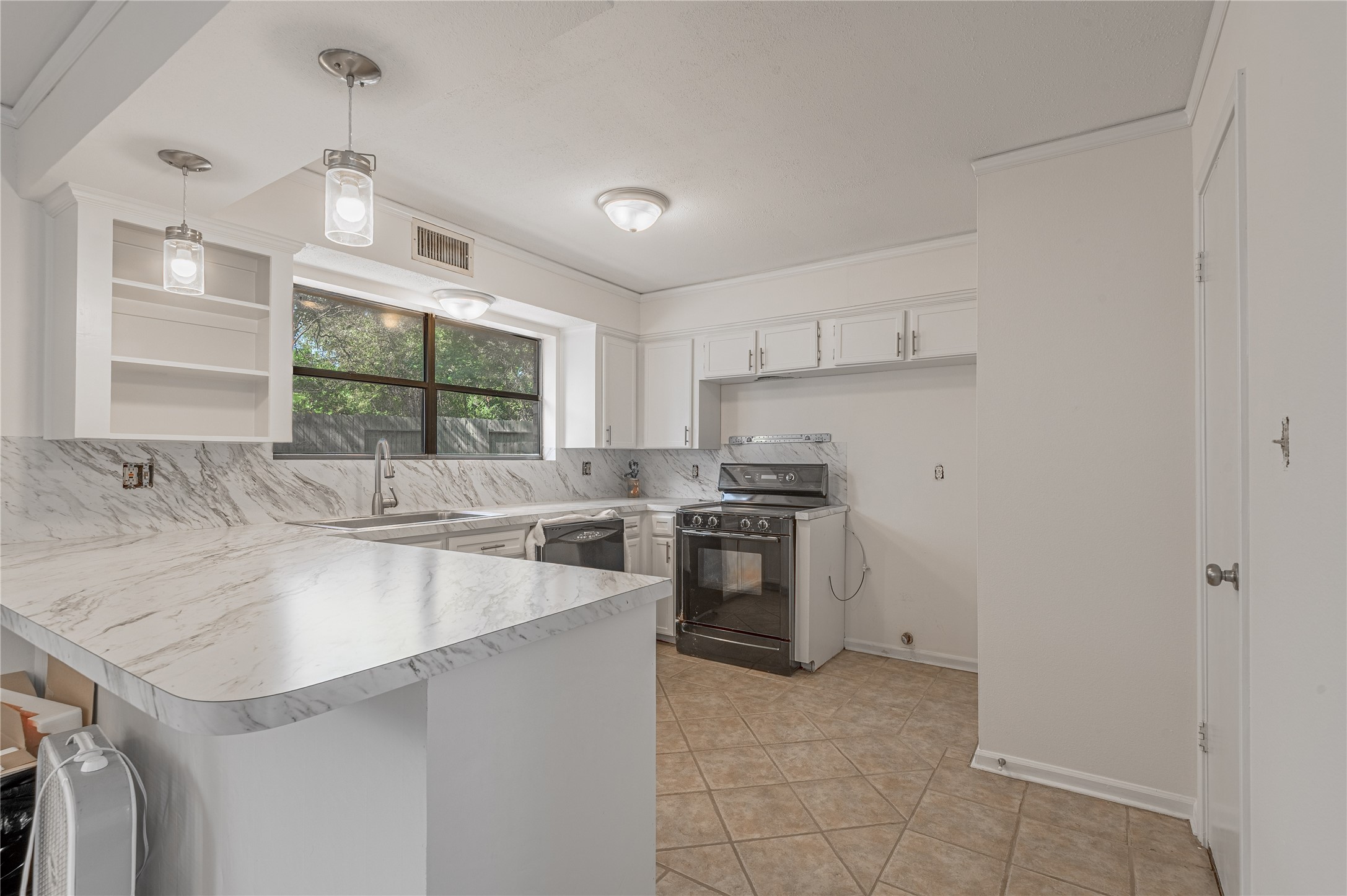 3644 Sage Street Huntsville, TX 77340 - Photo 13 of 20 a kitchen with stainless steel appliances granite countertop a sink stove and refrigerator