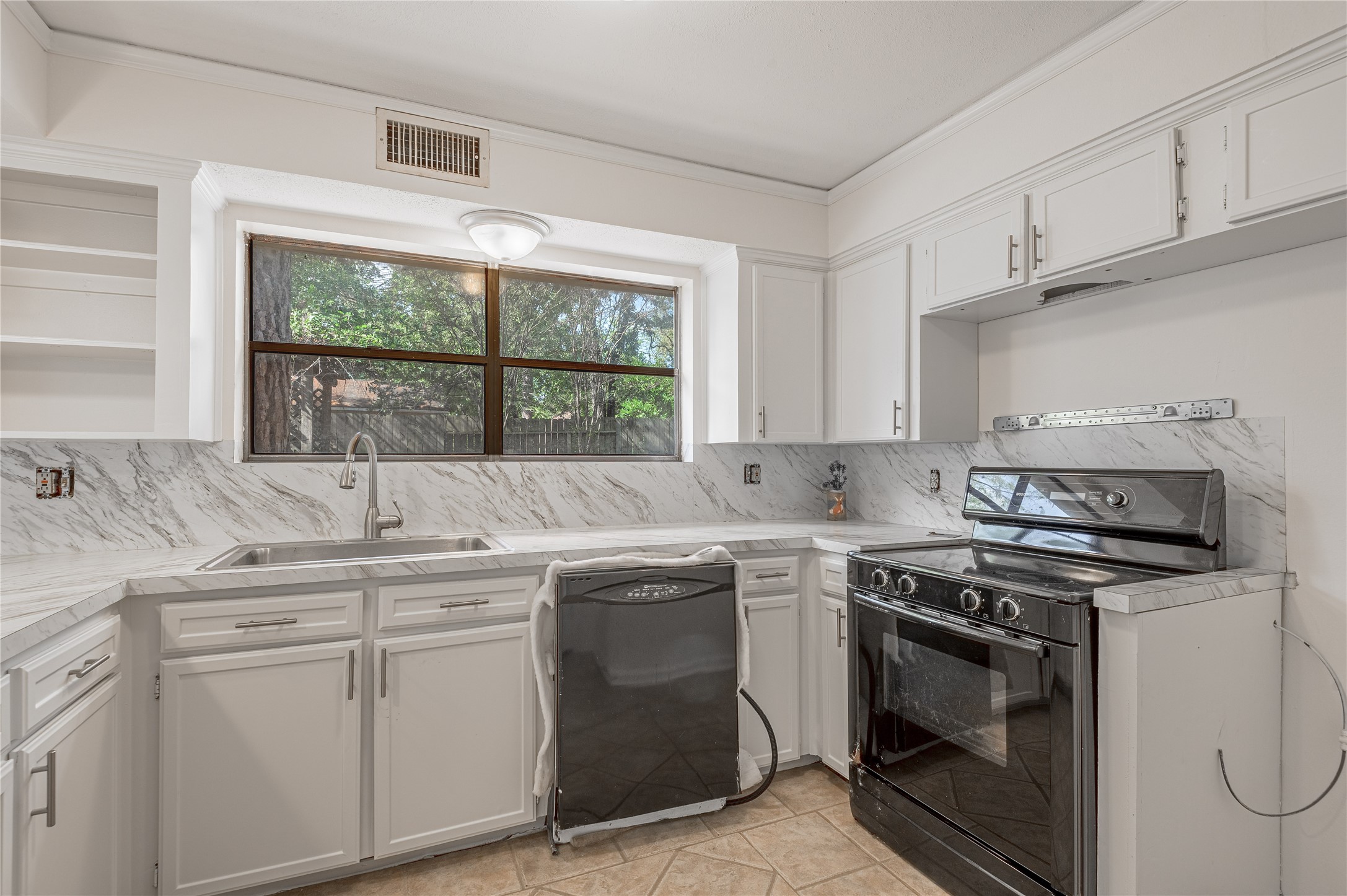 3644 Sage Street Huntsville, TX 77340 - Photo 14 of 20 a kitchen with stainless steel appliances granite countertop a sink and a stove