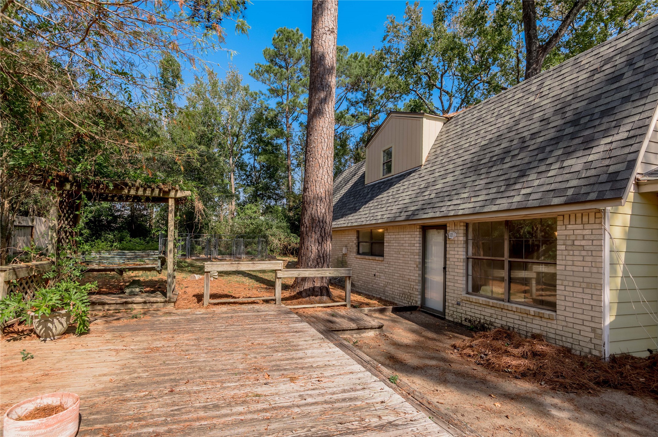 3644 Sage Street Huntsville, TX 77340 - Photo 20 of 20 a white house that has a tree on the side of it