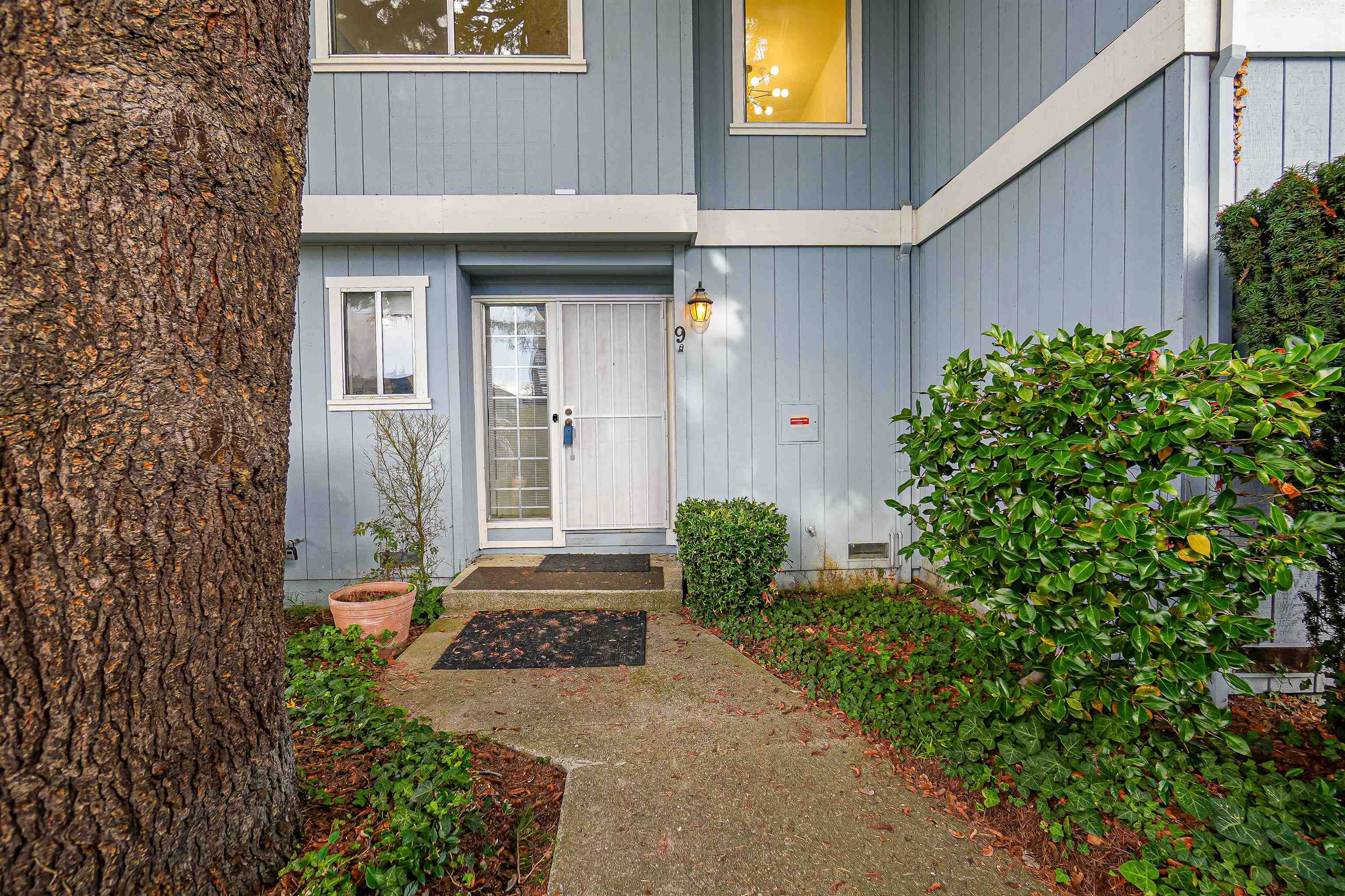 20115 Redwood Road, Unit 9 Castro Valley, CA 94546 - Photo 1 of 47 a front view of a house with garden