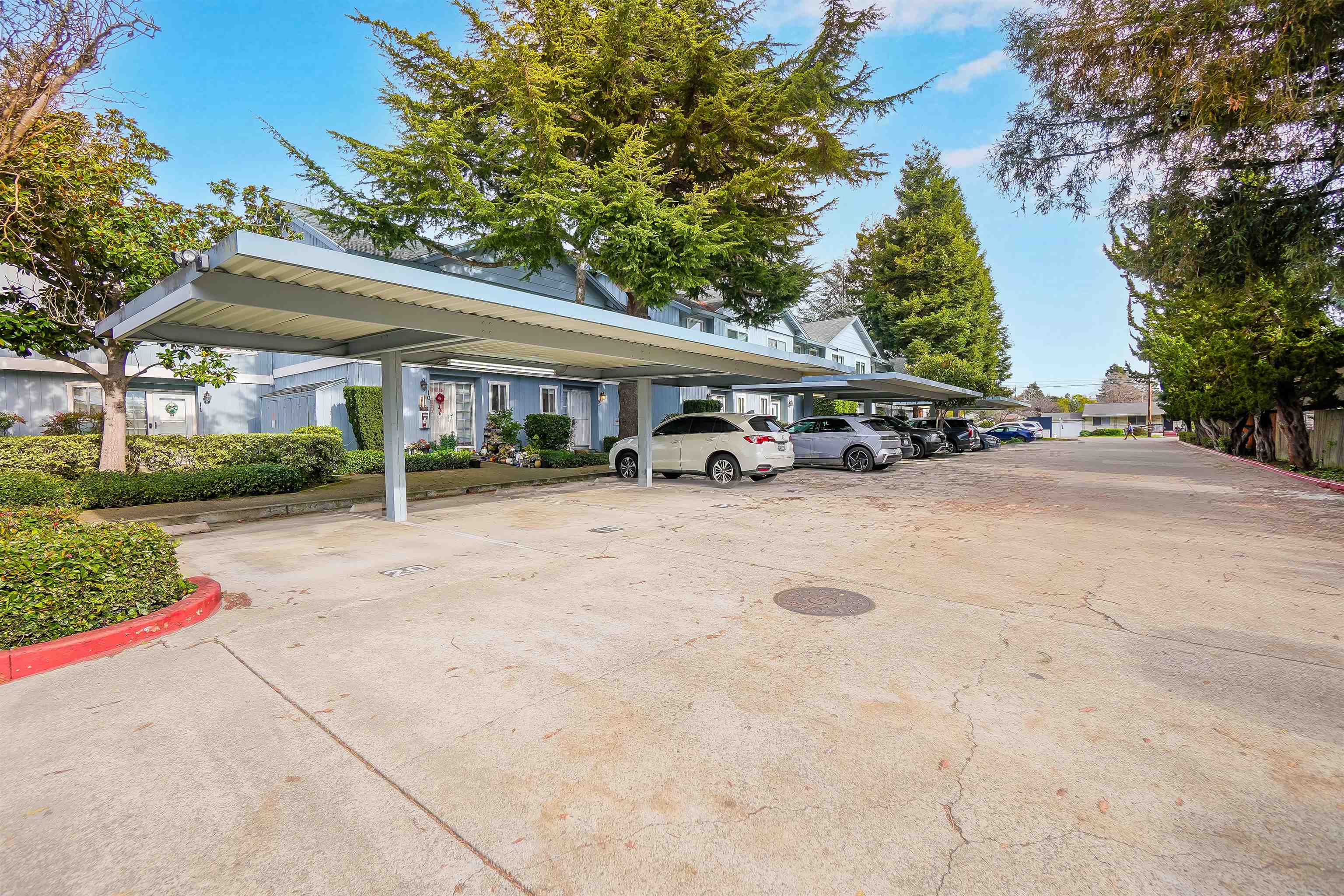 20115 Redwood Road, Unit 9 Castro Valley, CA 94546 - Photo 3 of 47 a view of a white house with a patio and a yard