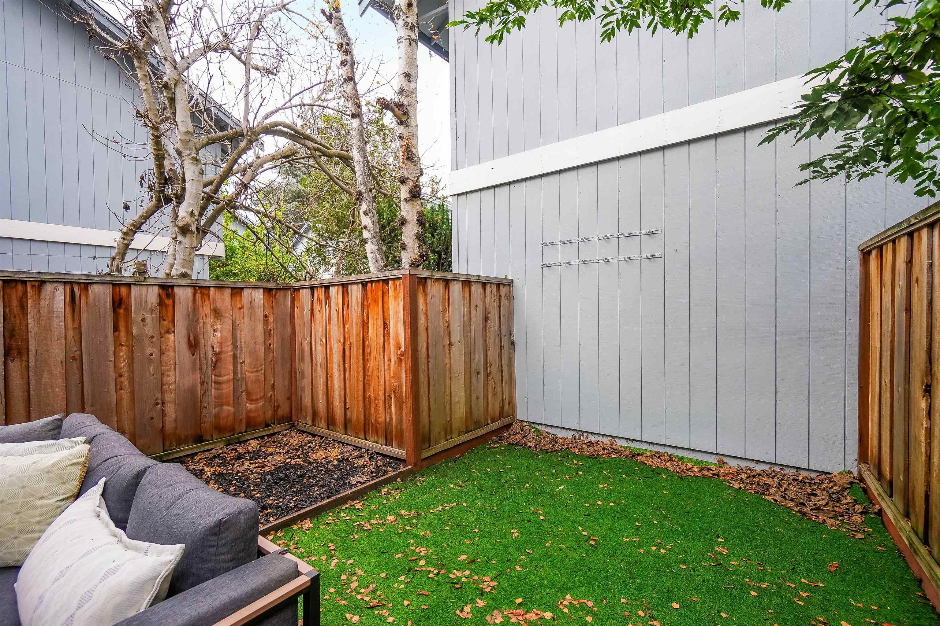 20115 Redwood Road, Unit 9 Castro Valley, CA 94546 - Photo 44 of 47 a view of a backyard with potted plants and a large tree
