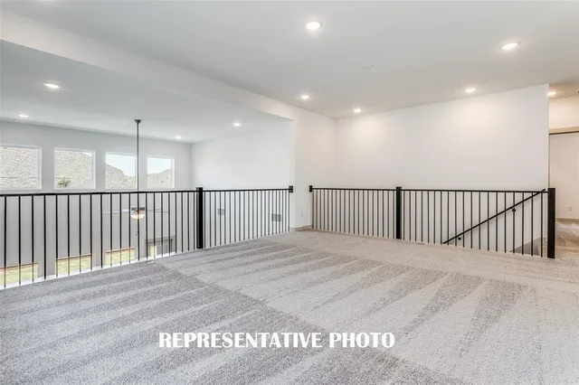 an empty room with wooden floor and entrance
