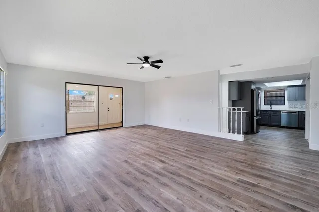 a view of a kitchen with wooden floor and window