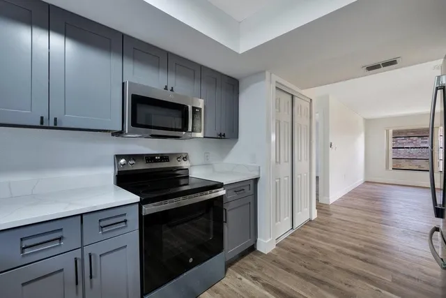 a kitchen with a stove and a microwave