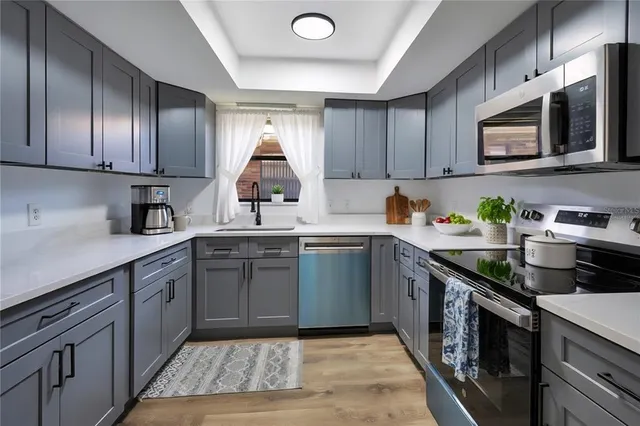a kitchen with a sink cabinets and window
