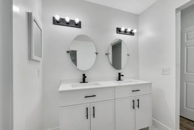 a bathroom with a sink and a mirror