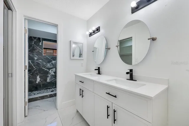 a bathroom with a sink a mirror and shower