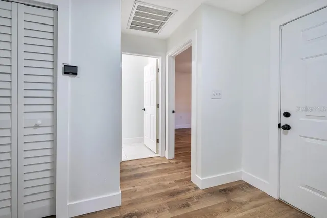 a view of a hallway with wooden floor