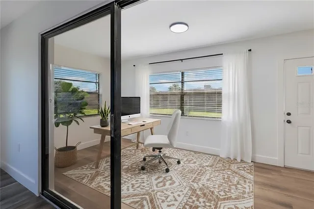 a bathroom with a glass door shower and a table