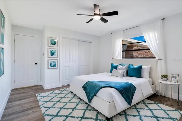 a bedroom with a bed and a painting on the wall