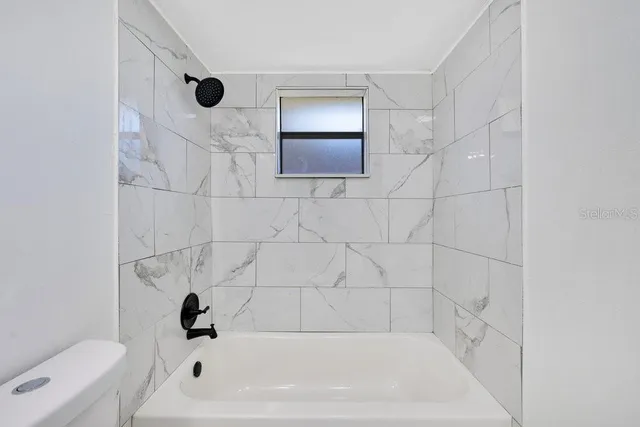 a bathroom with a bathtub and a toilet