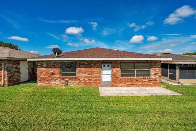 a view of a tennis ground with large trees