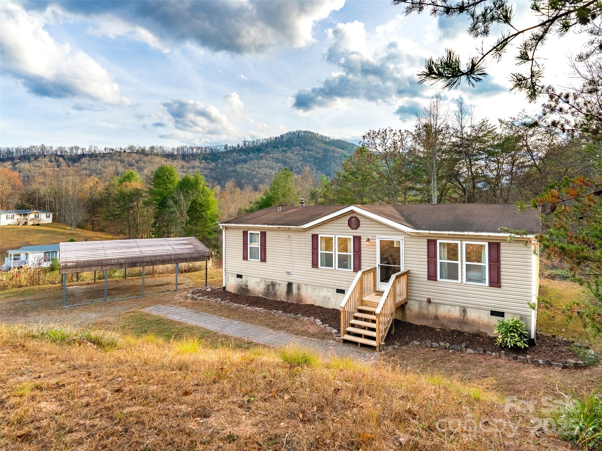 a view of a house with a yard and lake view