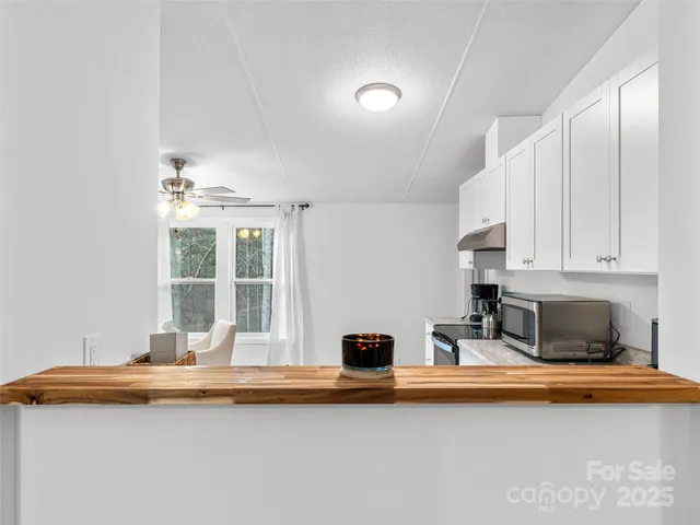 a dining hall with granite countertop a sink and a stove top oven