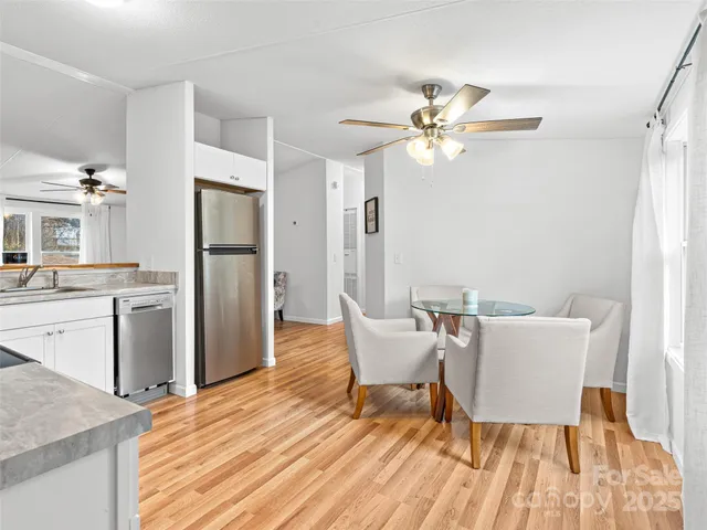 a living room with furniture a refrigerator and a table