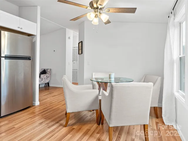 a dining room with furniture and wooden floor