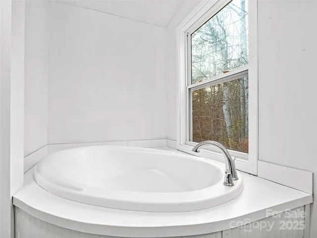 a white bath tub sitting in a bathroom