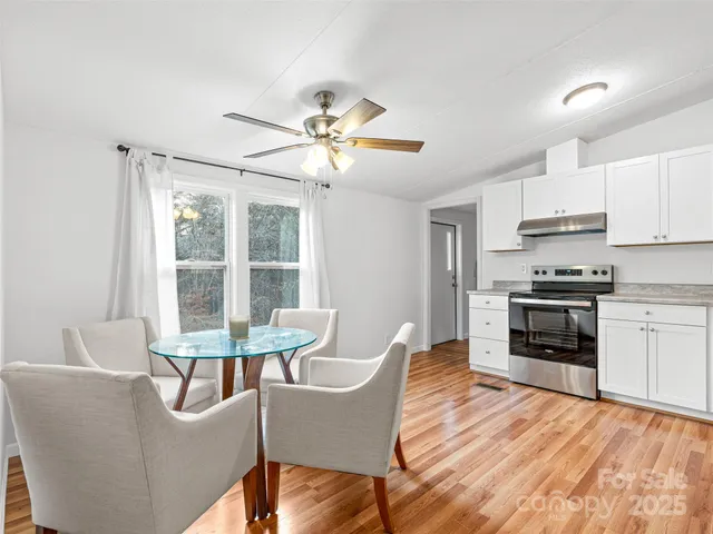 a dining room with furniture a window and wooden floor