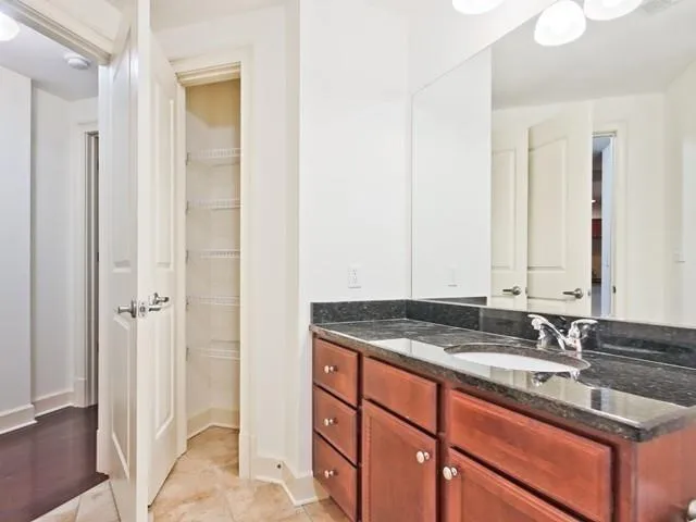 a bathroom with a double vanity sink and a mirror